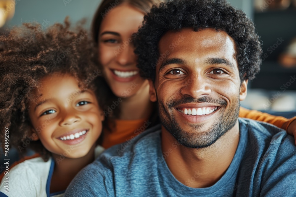 A smiling family of three, parents and their child, capturing a happy and cherished moment together at home, highlighting the joy and love within their bonds. A smiling family of three, parents and their child, capturing a happy and cherished moment together at home, highlighting the joy and love within their bonds.