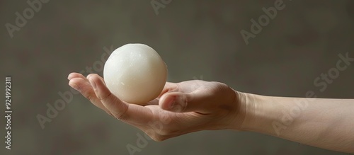 Isolated image of a hand holding a mochi or moci wijen with empty space for additional content photo