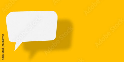 Empty speech balloon shape white paper isolated on yellow background communication bubbles.