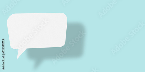 Empty speech balloon shape white paper isolated on light blue background communication bubbles.