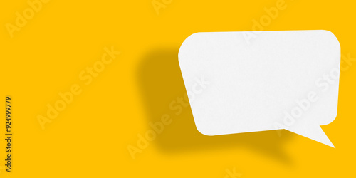 Empty speech balloon shape white paper isolated on yellow background communication bubbles.