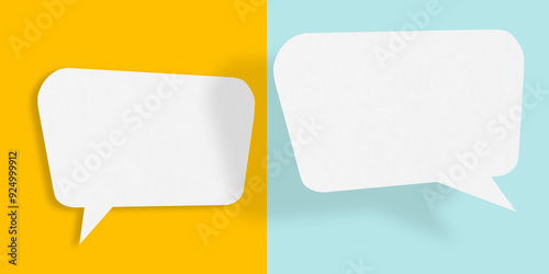 Empty speech balloon shape white paper isolated on yellow-light blue background communication bubbles.