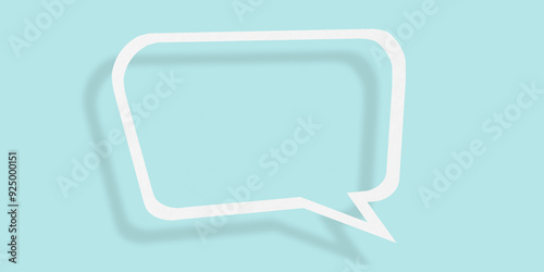 Empty transparent balloon paper speech bubble shape against light blue background.
