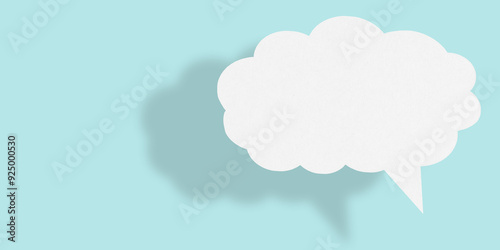 Empty white cloud paper speech bubble shape against light blue background.