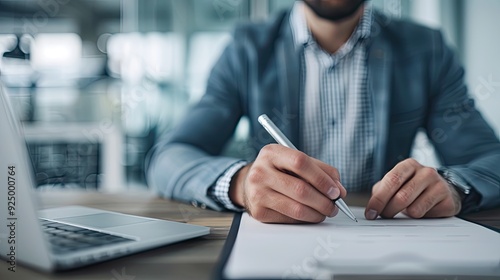 Man Engrossed in Writing at a Professional Office Desk