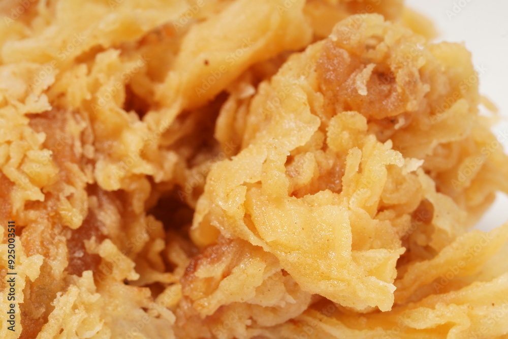 Golden fried chicken with a crispy, flour-coated skin, photographed against a white background. Golden fried chicken with a crispy, flour-coated skin, photographed against a white background.