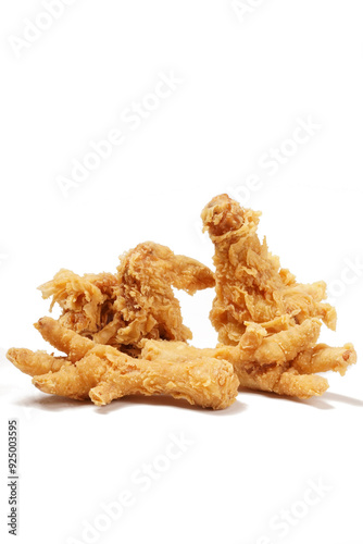 Golden fried chicken with a crispy, flour-coated skin, photographed against a white background.