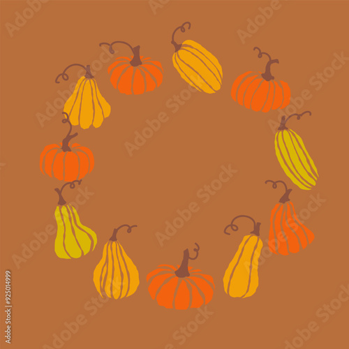 Colorful assortment of pumpkins arranged in a circular pattern against a brown background during autumn