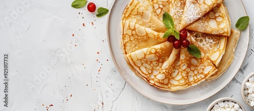 Delicious homemade breakfast featuring thin pancakes like Russian blini or French crepes served with cottage cheese captured in a top view copy space image photo