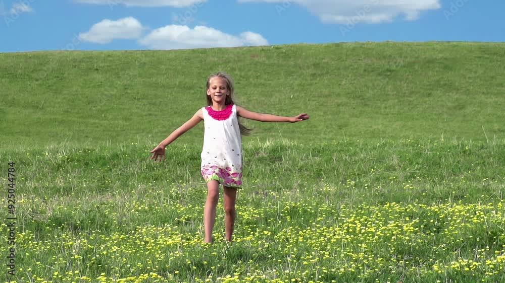 Girl Runs Across the Field. Girl in white dress runs across the field in the hills. Field strewn with yellow flowers. Slow Motion Girl Runs Across the Field. Girl in white dress runs across the field in the hills. Field strewn with yellow flowers. Slow Motion