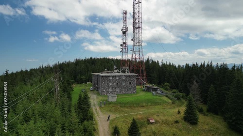 Drone shot of communication tower in rural mountain village of Romania. Mobile signals. Cellphone tower.Telecommunication tower with antennas. Wireless communication antenna transmitter, Romania photo