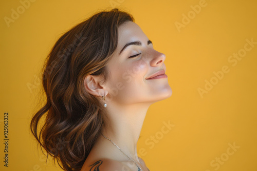 A close up of a woman's face with tattoos and her eyes closed