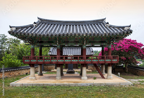 Gunsan-si, Jeollabuk-do, South Korea - July 23, 2022: Summer view of a tile roof pavilion with red flowers of crape myrtle at Okgu Hyanggyo(Confucian School) photo