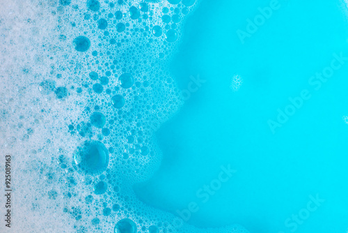 Foam in blue water. Blue foam. Water with foam bubbles. Blue background