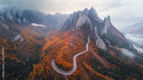 Aerial View of Scenic Mountain Road with Autumn Foliage & Majestic Peaks - Hyperrealistic Drone Photo