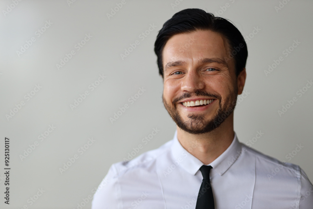 A man with a mustache and a black tie is smiling. He is wearing a white shirt and a black tie A man with a mustache and a black tie is smiling. He is wearing a white shirt and a black tie
