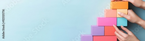 Colorful building blocks arranged creatively, portraying development, creativity, and fun. Ideal for educational and playful themes.