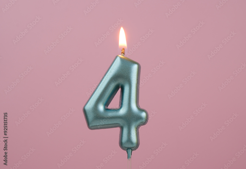 Burning blue birthday candle on pink background, number 4