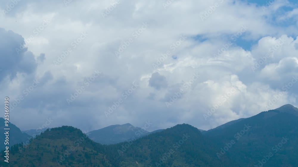 4K Zoom In Time-lapse shot of dark clouds above the Pir Panjal ranges of the Himalayas as seen from Naggar in Himachal Pradesh, India. Monsoon clouds above the green mountains at Naggar near Manali. 4K Zoom In Time-lapse shot of dark clouds above the Pir Panjal ranges of the Himalayas as seen from Naggar in Himachal Pradesh, India. Monsoon clouds above the green mountains at Naggar near Manali.