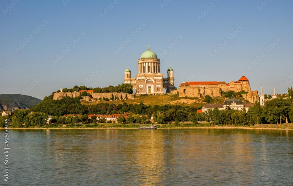 Primatial Basilica of The Assumption of The Blessed Virgin Mary and St Adalbert. Panoramic View at Sunset. Basilica in Esztergom, Hungary. Discover the history and beauty of Hungary. Primatial Basilica of The Assumption of The Blessed Virgin Mary and St Adalbert. Panoramic View at Sunset. Basilica in Esztergom, Hungary. Discover the history and beauty of Hungary.