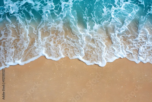A top down aerial view of beach shoreline gentle waves on a sandy beach in australia