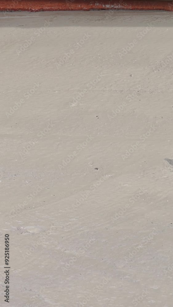 Construction worker leveling of concrete by using special tools