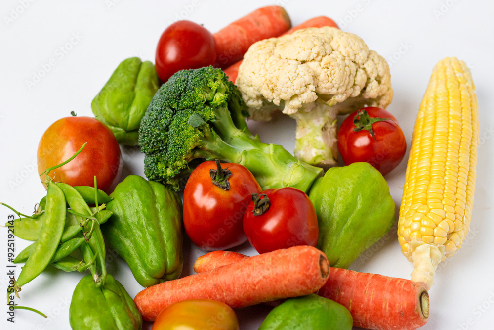 Assorted fresh vegetables on isolated white background, showing various colors and textures Assorted fresh vegetables on isolated white background, showing various colors and textures