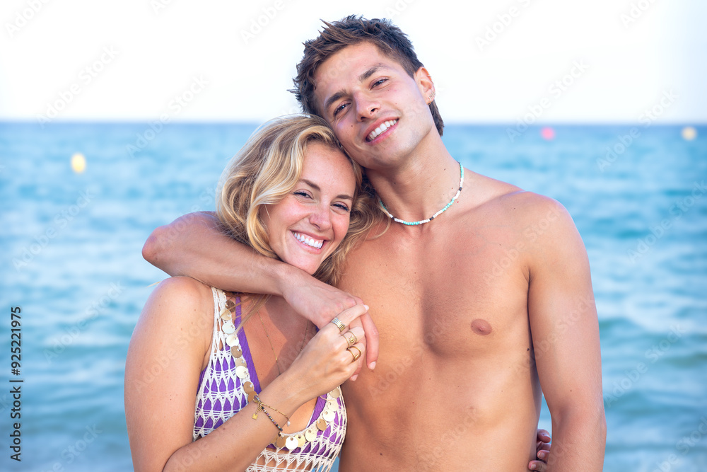 Smiling multiethnic woman and man enjoying vacation. Beautiful and cheerful couple of generation z pose for a photo with a mobile phone. Smiling multiethnic woman and man enjoying vacation. Beautiful and cheerful couple of generation z pose for a photo with a mobile phone.