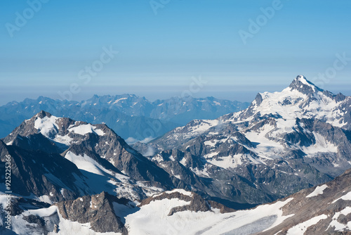 highlands landscape, mountain ranges with glaciers in atmospheric haze photo