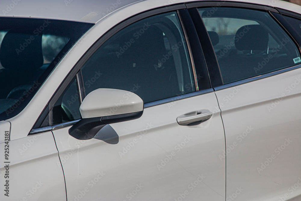 Left door with rear view mirror of a white car
Left door with rear view mirror of a white car