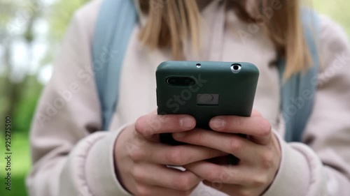 Schoolgirl On Smartphone Chatting With Friends On Social Media