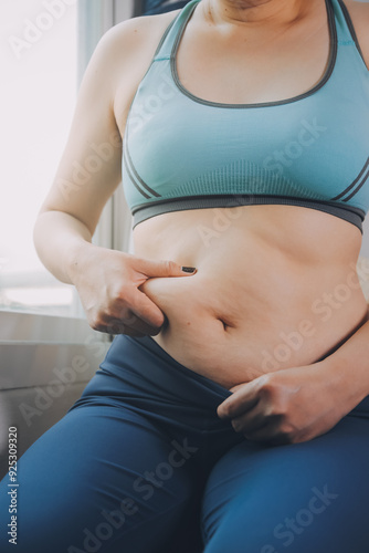 fat woman, fat belly, chubby, obese woman hand holding excessive belly fat with measure tape, woman diet lifestyle concept