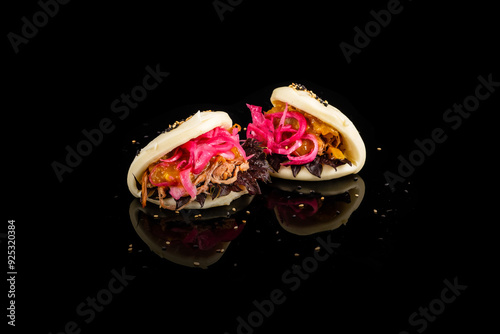 Fototapeta Naklejka Na Ścianę i Meble -  Exquisite Asian bao buns with vibrant fillings on black