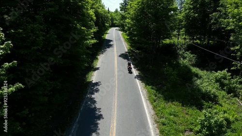 Cyclotourist rinding his bike climbing a mountain in Estrie Quebec Canada photo