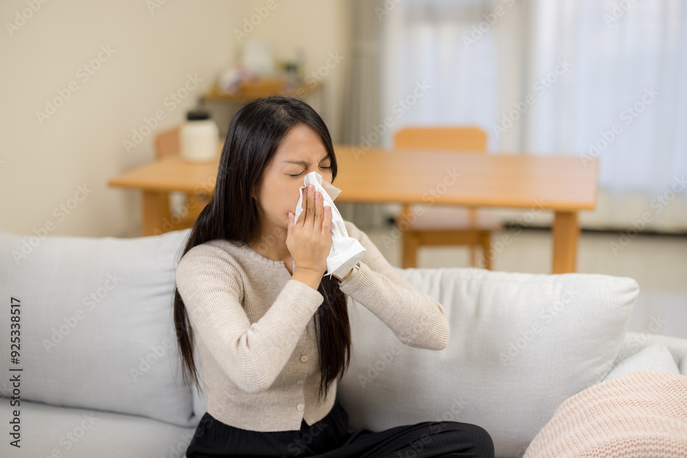 Woman suffer from influenza and sneeze at home Woman suffer from influenza and sneeze at home