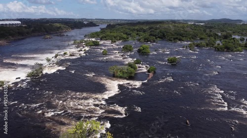 The shot reveals the immense Caroní River and a section of the adjacent forest. photo