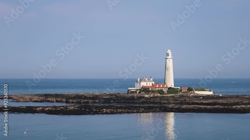 Old White Lighthouse On The Island In Calm Weather photo