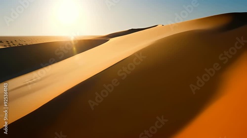 Video of vast, sunlit desert with rolling sand dunes stretching into distance, serene and desolate beauty of desert environment, solitude, nature's raw power, stark contrasts of natural world