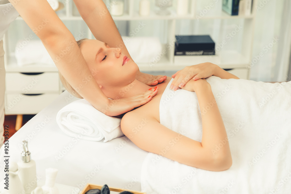 Fototapeta premium Caucasian woman customer enjoying relaxing anti-stress spa massage and pampering with beauty skin recreation leisure in day light ambient salon spa at luxury resort or hotel. Quiescent