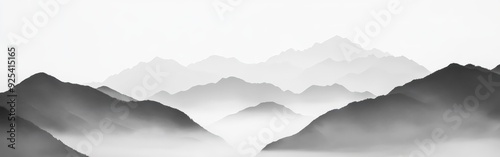 Foggy mountains at noon create a serene landscape in the distance