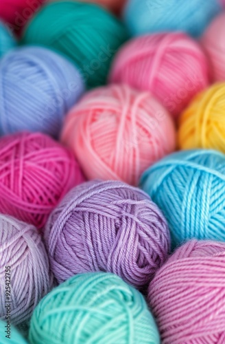 Colorful Yarn Balls in Various Shades Arranged on a Purple Background