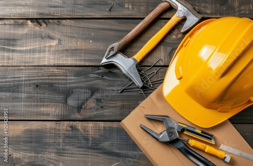 Construction Tools and Safety Gear on Wooden Workbench in Workshop