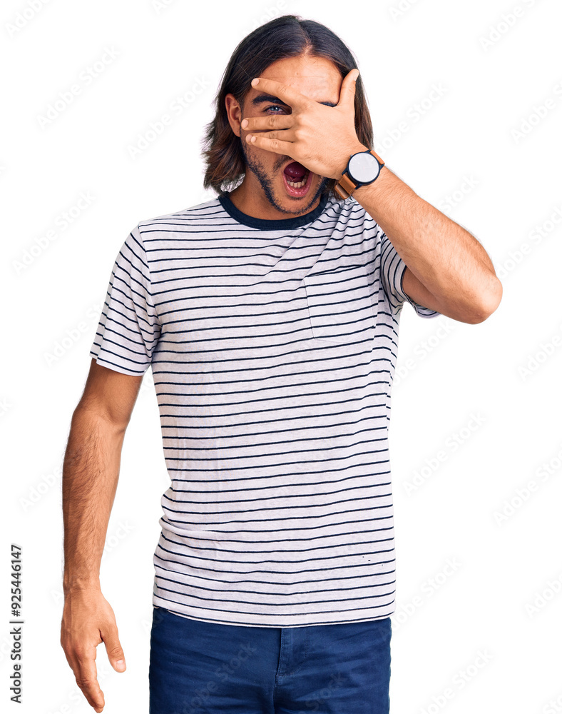 Young handsome man wearing casual clothes peeking in shock covering face and eyes with hand, looking through fingers with embarrassed expression. Young handsome man wearing casual clothes peeking in shock covering face and eyes with hand, looking through fingers with embarrassed expression.