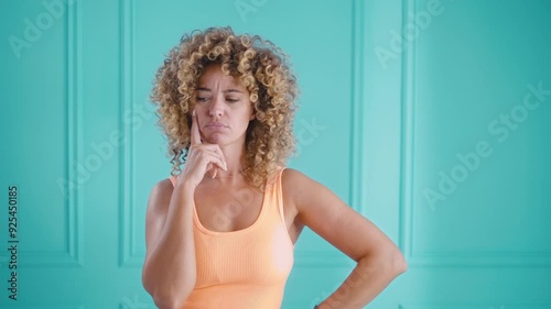 Portrait of woman thinking hard expressing hesitation and indecision
