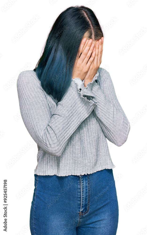 Young modern girl wearing casual sweater with sad expression covering face with hands while crying. depression concept. Young modern girl wearing casual sweater with sad expression covering face with hands while crying. depression concept.