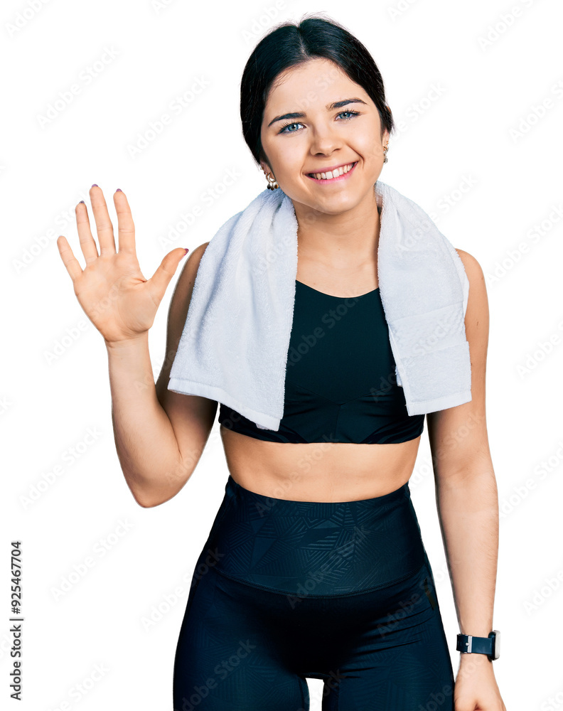 Young brunette woman with blue eyes wearing sportswear and towel showing and pointing up with fingers number five while smiling confident and happy. Young brunette woman with blue eyes wearing sportswear and towel showing and pointing up with fingers number five while smiling confident and happy.