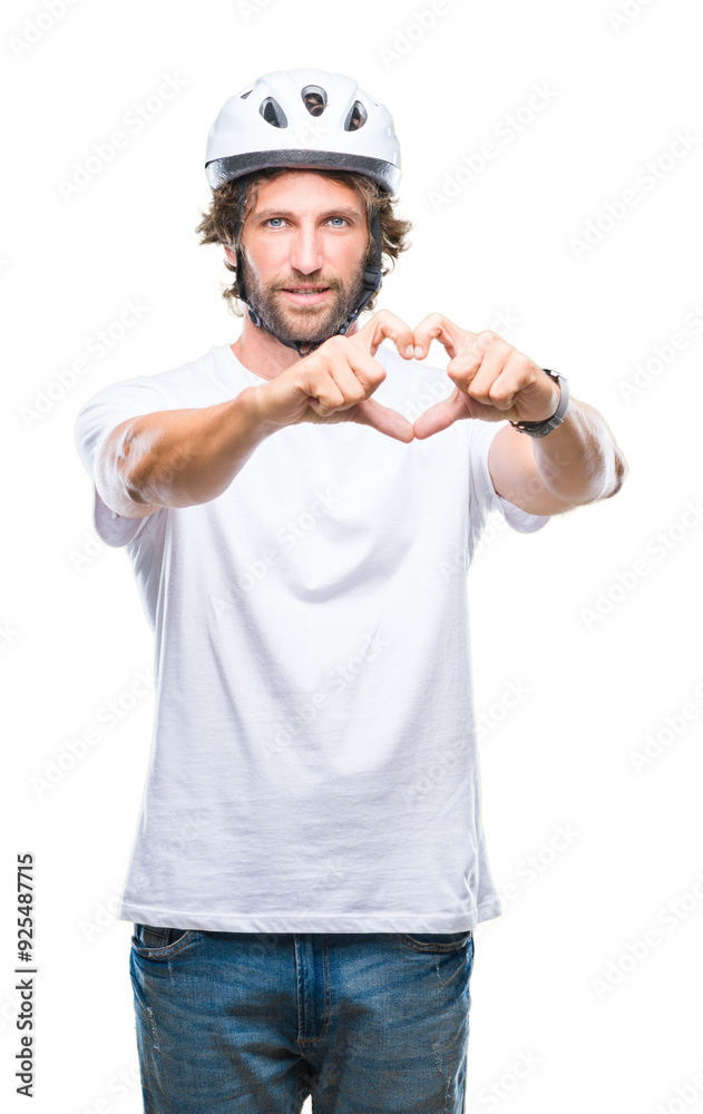 Handsome hispanic cyclist man wearing safety helmet over isolated background smiling in love showing heart symbol and shape with hands. Romantic concept. Handsome hispanic cyclist man wearing safety helmet over isolated background smiling in love showing heart symbol and shape with hands. Romantic concept.