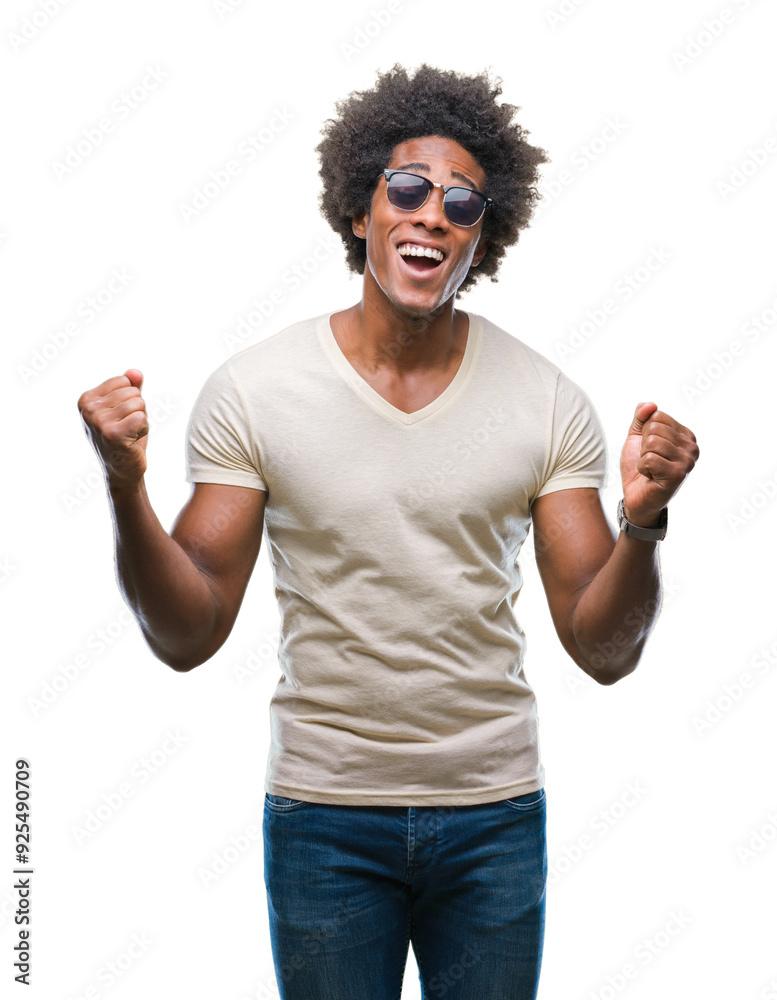 Afro american man wearing sunglasses over isolated background very happy and excited doing winner gesture with arms raised, smiling and screaming for success. Celebration concept. Afro american man wearing sunglasses over isolated background very happy and excited doing winner gesture with arms raised, smiling and screaming for success. Celebration concept.