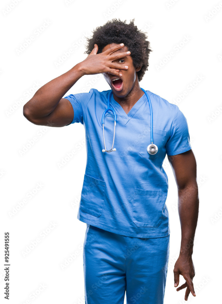 Afro american surgeon doctor man over isolated background peeking in shock covering face and eyes with hand, looking through fingers with embarrassed expression. Afro american surgeon doctor man over isolated background peeking in shock covering face and eyes with hand, looking through fingers with embarrassed expression.