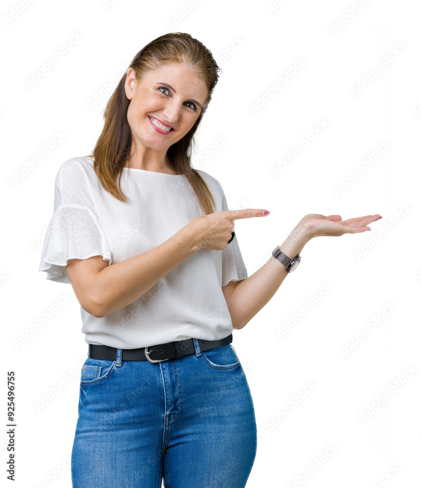 Middle age mature beautiful woman over isolated background amazed and smiling to the camera while presenting with hand and pointing with finger. Middle age mature beautiful woman over isolated background amazed and smiling to the camera while presenting with hand and pointing with finger.